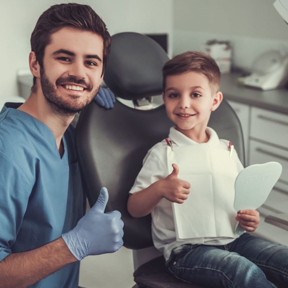 Child smiling during a dental consultation.